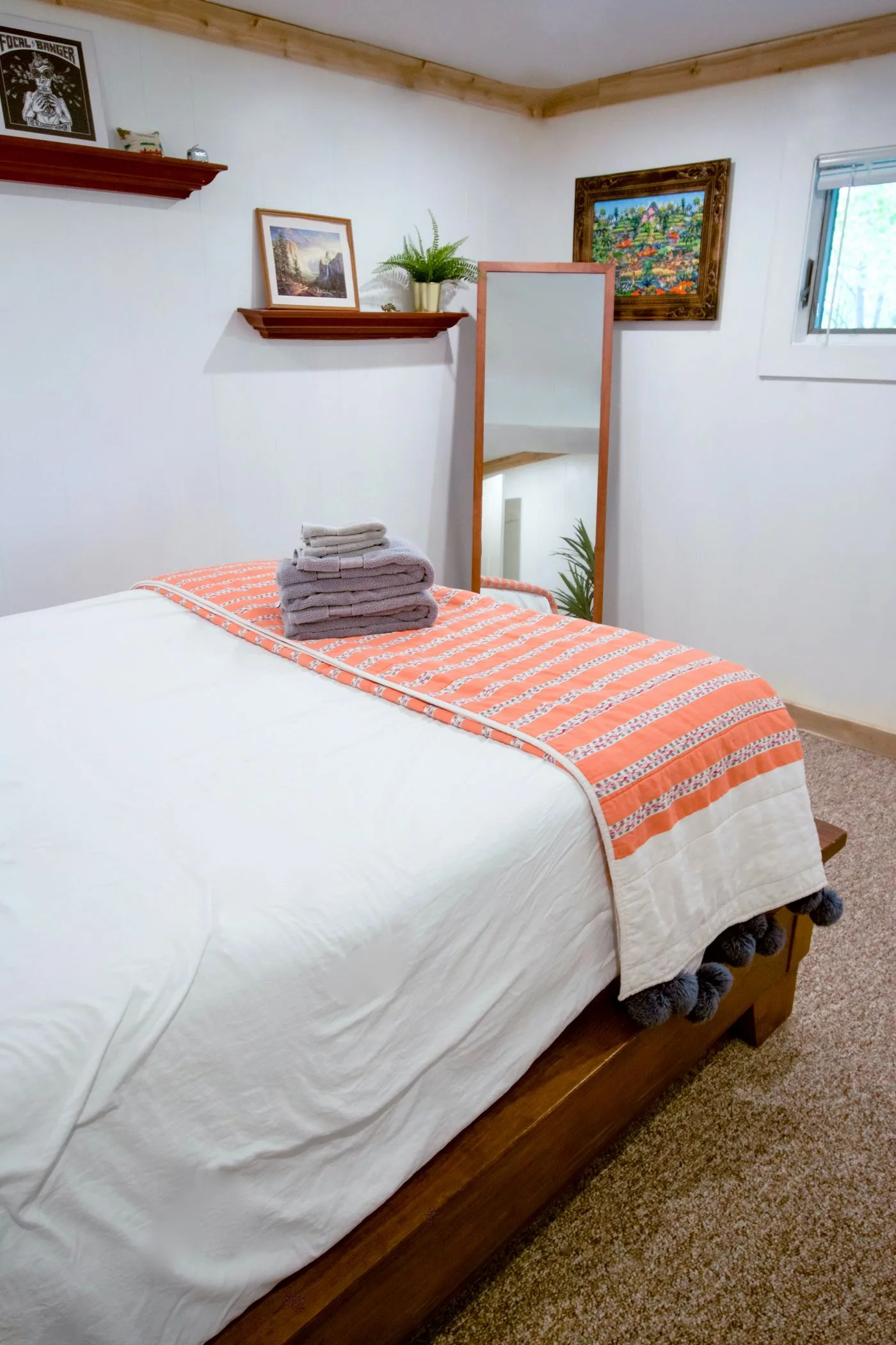 A bedroom with simple, neutral furnishings